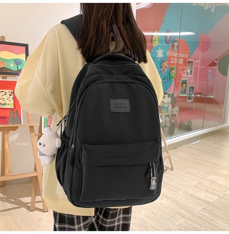 Student Japanese large-capacity backpack Girl simple and versatile backpack Unisex polyester material Doll decoration