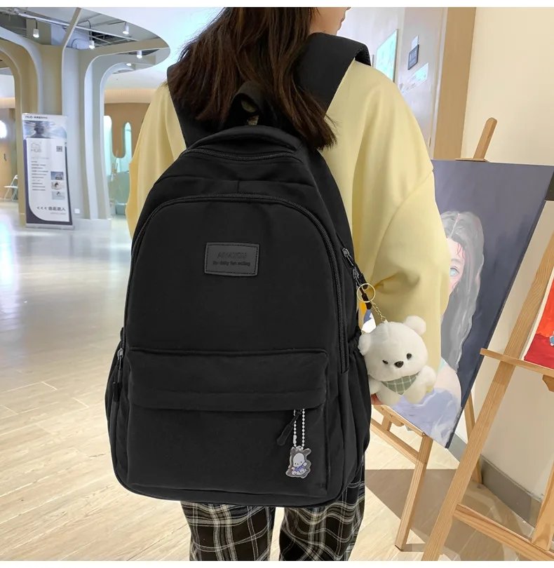 Student Japanese large-capacity backpack Girl simple and versatile backpack Unisex polyester material Doll decoration